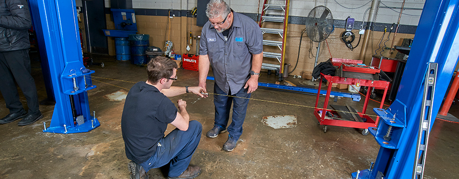 Two Allied workers measuring and ensuring proper lift alignment during an installation